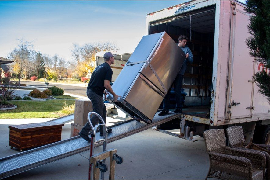Ace Movers loading a refrigerator up the truck ramp